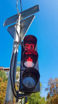 red traffic light with time delay. Vertical photo. Traffic light on a taxi with a stop signal in the daytime.