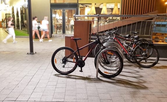 Ukraine, Kiev - September 07, 2019: a small area with parking for bicycles and a small fast food cafe in the evening.
