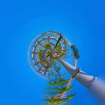 Abstract rollercoaster ride against blue sky and flowers