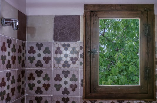 Vintage rural hotel bathroom covered with old cement tiles..Rural tourism concept