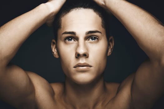 Beauty portrait of young handsome man against blue background