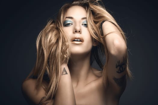 Beauty portrait of young sexy woman against blue background