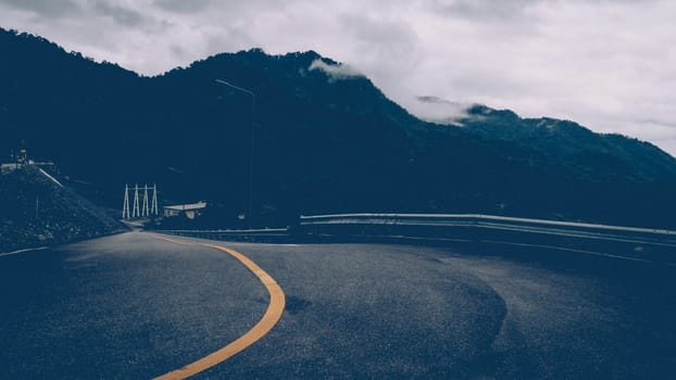 Asphalt road with yellow line curve. Black and yellow asphalt road, Road curve, Road Background, angle, highway, material. Curved Road With Yellow Line.