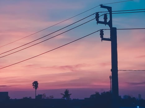 The electric pole and electric transformer at sunset orange sky