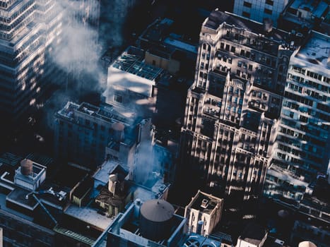 New York City, USA. Midtown Manhattan building rooftops with steam comming from the heating systems.