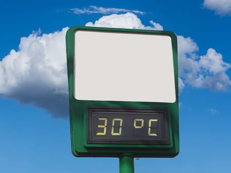 Electronic large thermometer on the building, indicating a high summer air temperature 30 degrees Celsius. Summer hot weather, heat