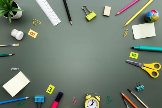 Back to school conceptual flat lay with different office supply objects and copy space area for text. Concept for primary and secondary school pupil on green background. Alarm clock, eraser, ruler