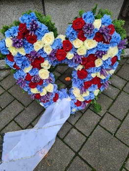 Heart of roses in front of a grave