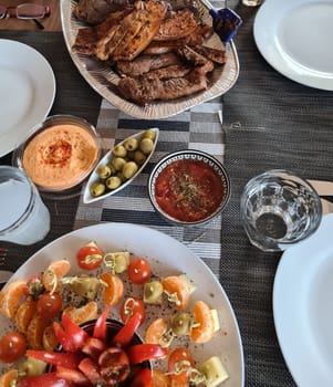 Cheese plate served with Grilled meat and vegetables on rustic wooden table
