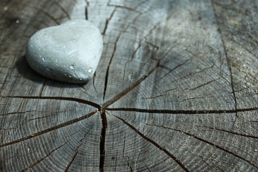 a heart of stone on wooden ground