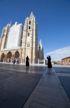 Leon, Spain - June 25th, 2019: Friars visiting Leon Cathedral, Spain. Main Entrance