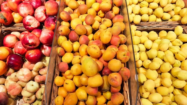 many fruit crates for sale in the fruit market. Apricot and peach in a shop window.