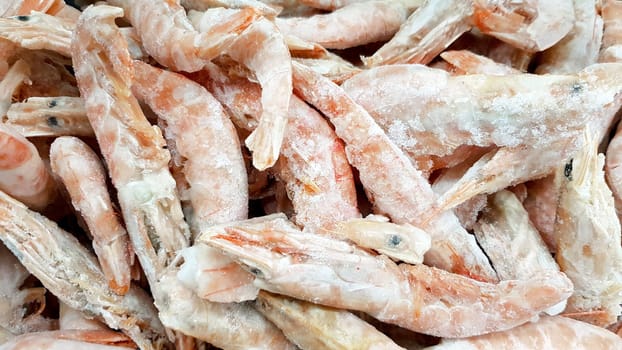 Frozen shrimps in ice. A lot of royal shrimp close-up