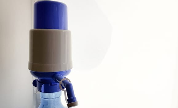 pump on a water bottle. Close-up on a white background.