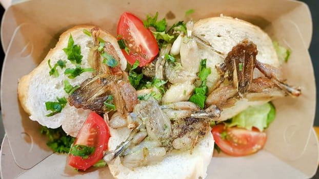 Cambodian dish grilled frog. Tasty exotic dishes are served in the restaurant. Street food frog legs.