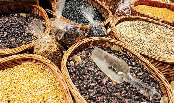 At market stalls beans, lentils, peas, chickpeas. Vegan Squirrels. Organic healthy fresh food market. Green grass blurred on background. Plant diet.