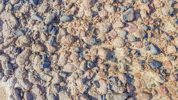 Background of Red sea water surface and sandy bottom. Sandy sea floor with structure of sunlight in the red sea