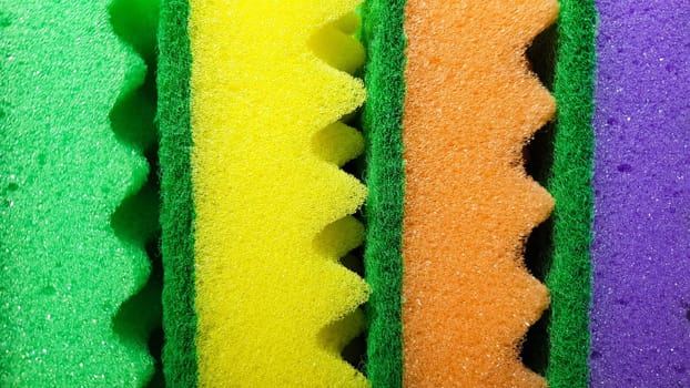 Multi-colored washcloths are laid out in rows on a bright background, close-up. place for text. Copy space.