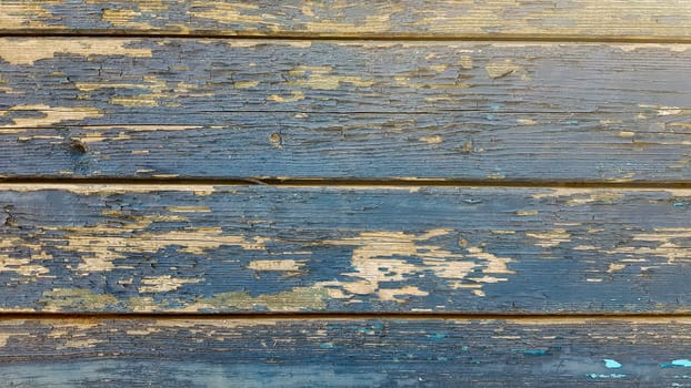 backgrounds and texture concept - old wooden fence painted in blue background.