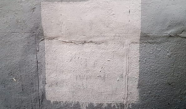 Gray concrete wall. Large coarse strokes of paint on the surface of the house. Close-up. Classic background. Copy space. Place for text