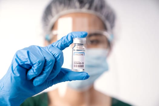 close-up scientist holding vaccine coronavirus in lap