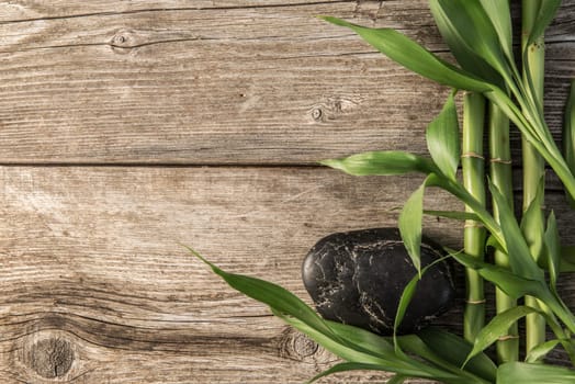zen basalt stones and bamboo on the wooden baord background