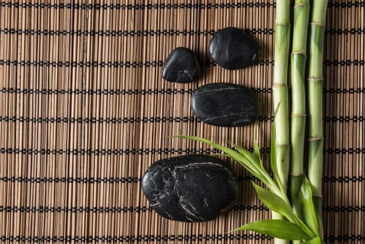 zen basalt stones and bamboo on the mat
