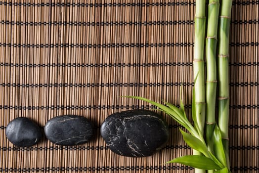 zen basalt stones and bamboo on the mat