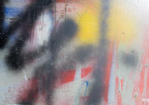 Fragment of black abstract graffiti on a metal fence. Spray paint