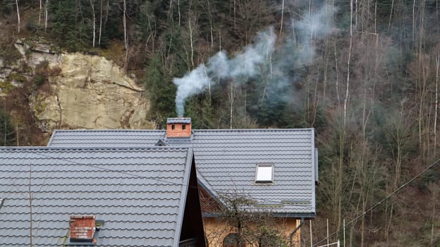 View of the picturesque village houses and cottages against the backdrop of mountains. The city of Yaremche among the Carpathians in the autumn afternoon. Ukraine, Yaremche - November 20, 2019.