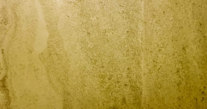 Gold background or texture and gradient shadow. wall and floor gold yellow mosaic tiles texture background. Metal texture background in gold.Panorama gold texture.