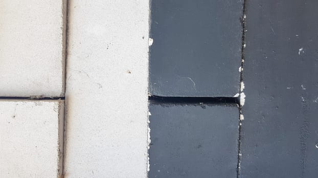 black and white bricks piled equally in a pile. Close-up. Black-white stone background.