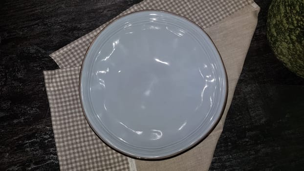 Large glass vases, a basket with apples and plates in the interior of a modern kitchen. The combination of wood and concrete in the design. Modern style dining kitchen.