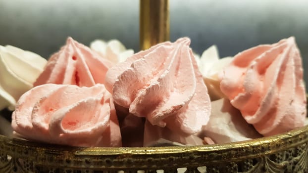 Color sweet homemade meringues and marshmallows. Airy and tender pastry marshmallows dessert. The sweet dish you want to eat. Sweets in the dark