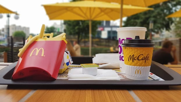 Hamburger, French fries, coffee and Coca Cola soft drink on the table in the McDonald's restaurant. Branches all over the world. Ukraine, Kiev - September 6, 2019