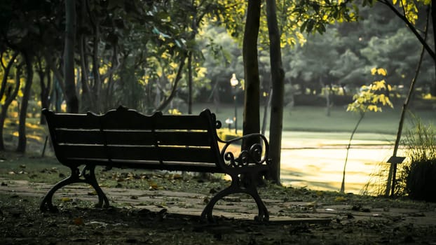 Background of city park in spring with trees, bushes and bench. island  and the lake