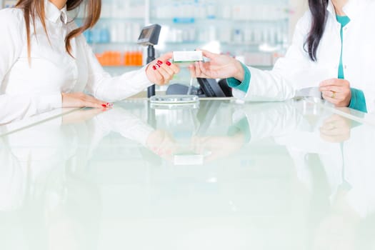 pharmacist suggesting medical drug to buyer in pharmacy