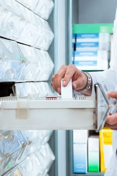 cropped view of pharmacist taking medicine from drawer. Copy space