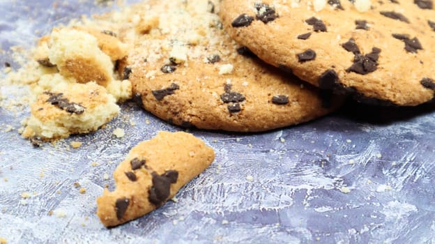 Soft, freshly baked chocolate chip cookies on a gray marble kitchen countertop. American traditional sweet pastry pastry, delicious homemade dessert. Culinary background