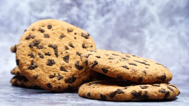 Soft, freshly baked chocolate chip cookies on a gray marble kitchen countertop. American traditional sweet pastry pastry, delicious homemade dessert. Culinary background