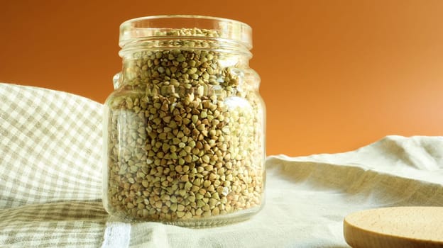 Green sprouts of raw organic buckwheat in a glass jar for cereals. Vegan food concept. Organic food. The concept of diet, weight loss, healthy and proper nutrition. Copy space for text