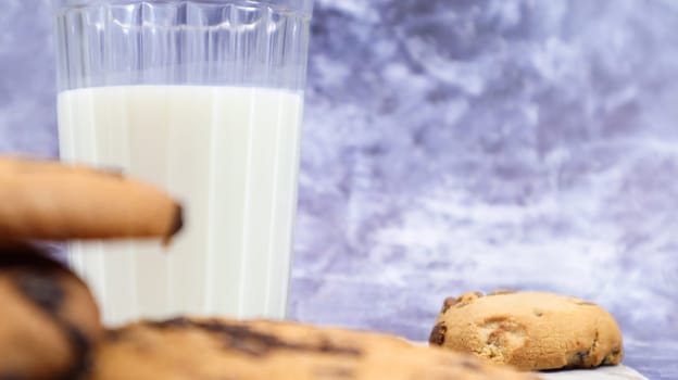 American gluten free chocolate chip cookies with glass glass of vegetable milk on gray background. Chocolate chip cookies. Sweet pastries, dessert. Culinary background. Copy space.