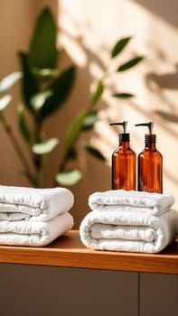 Spa treatment set, wooden shelf with neatly folded towels and dispensers for soap, cream, massage oil. High quality photo