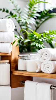 Spa treatment set, wooden shelf with neatly folded towels and dispensers for soap, cream, massage oil. High quality photo