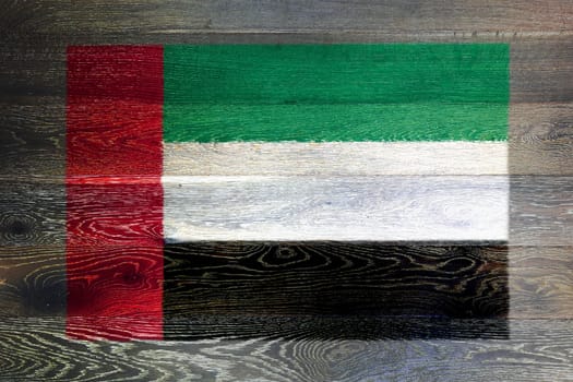 A United Arab Emirates flag on wood background
