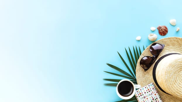Travel, vacation concept. Hat with different sea shells, green palm leaf, passport, eyeglasses and cup of coffee on blue sky background. Travelling to warm countries. Banner with copy space for text
