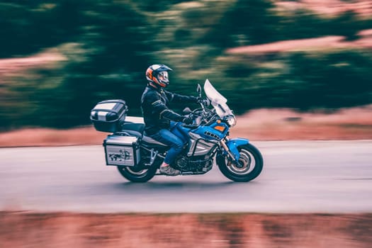 Motorcycle driver driving in beautiful sunset.