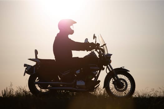 Motorcycle driver riding on countryside. Travel and sport, speed and freedom concept