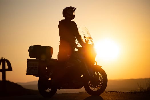 Motorcycle driver riding on countryside. Travel and sport, speed and freedom concept