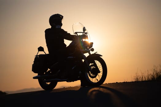 Motorcycle driver riding on countryside. Travel and sport, speed and freedom concept